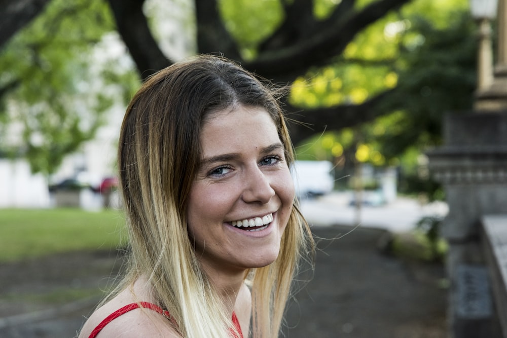 smiling woman in red tank top