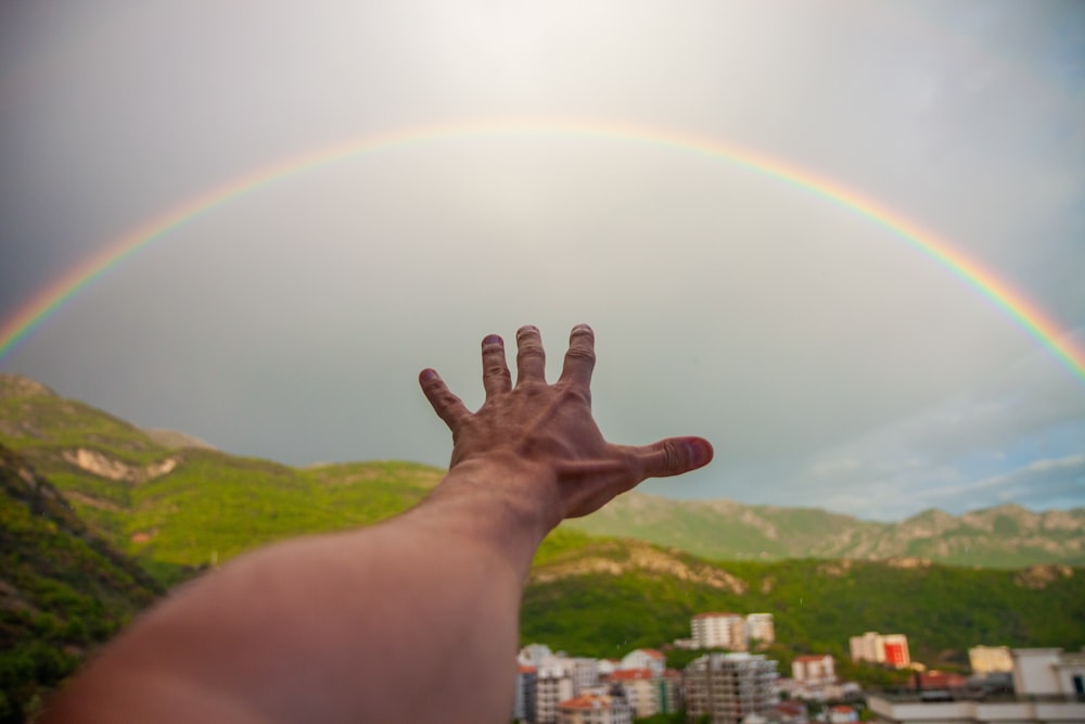persons left hand with rainbow