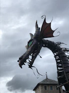 Close-up of a cybernetic dragon's eye reflecting golden circuits and stars.