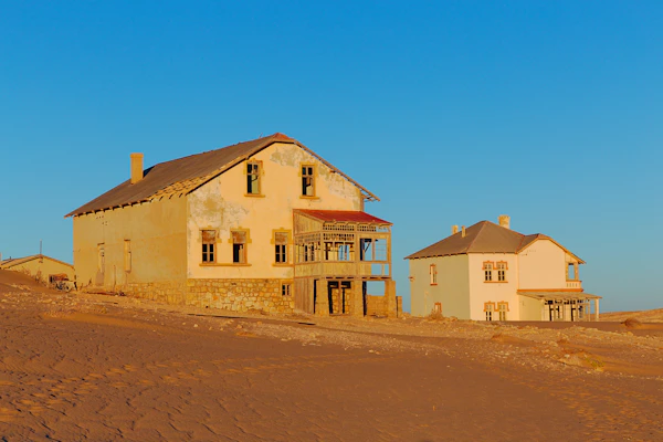 Exterior view of Kolmanskop buildings against desert sky
