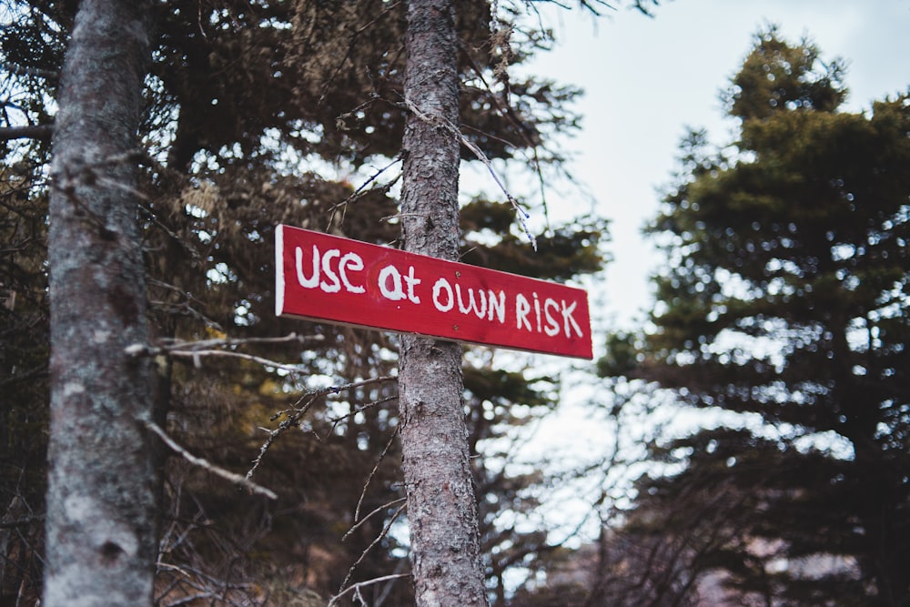 a close up of a street sign on a tree