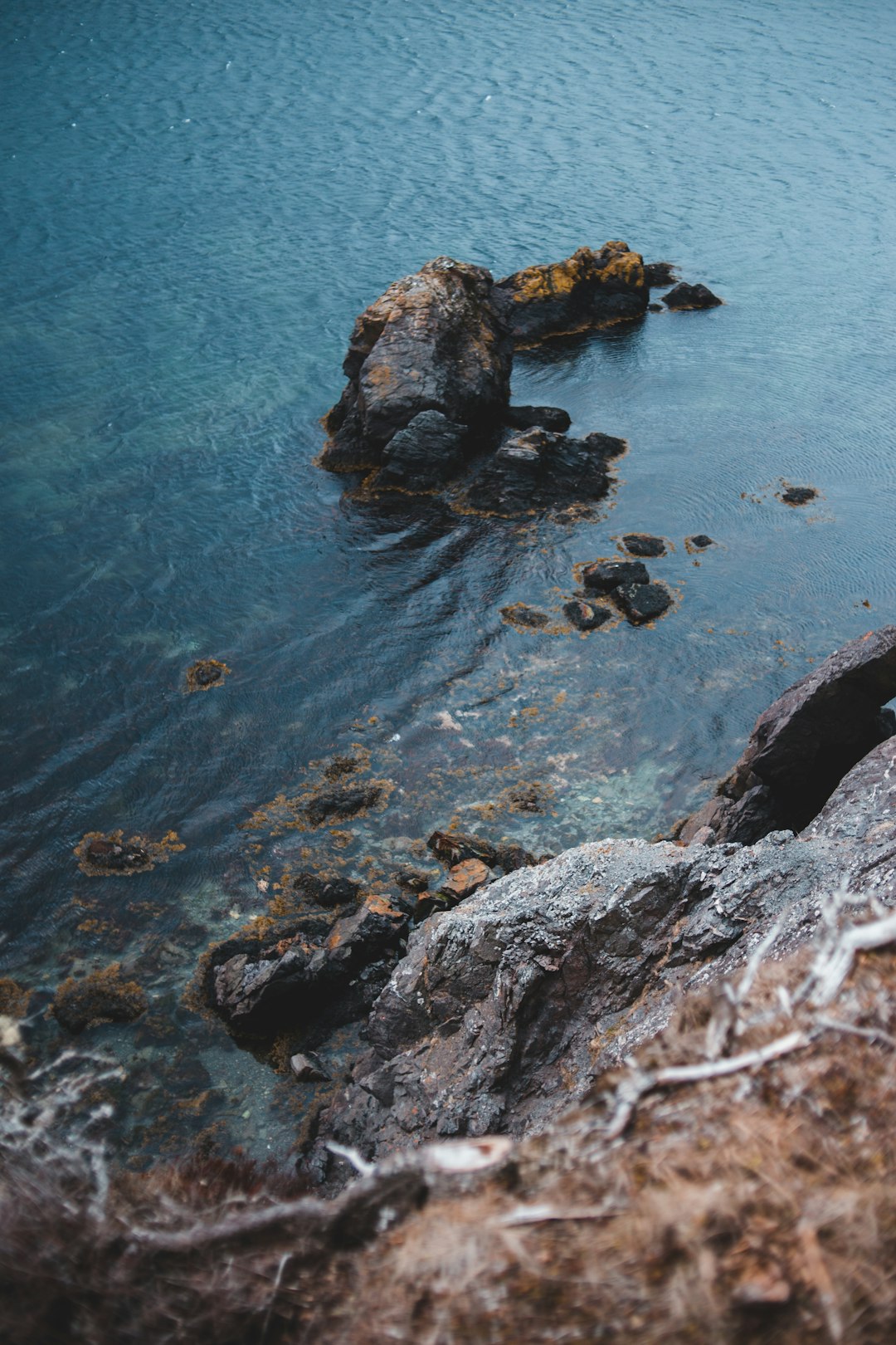 brown rock formation on blue sea water during daytime