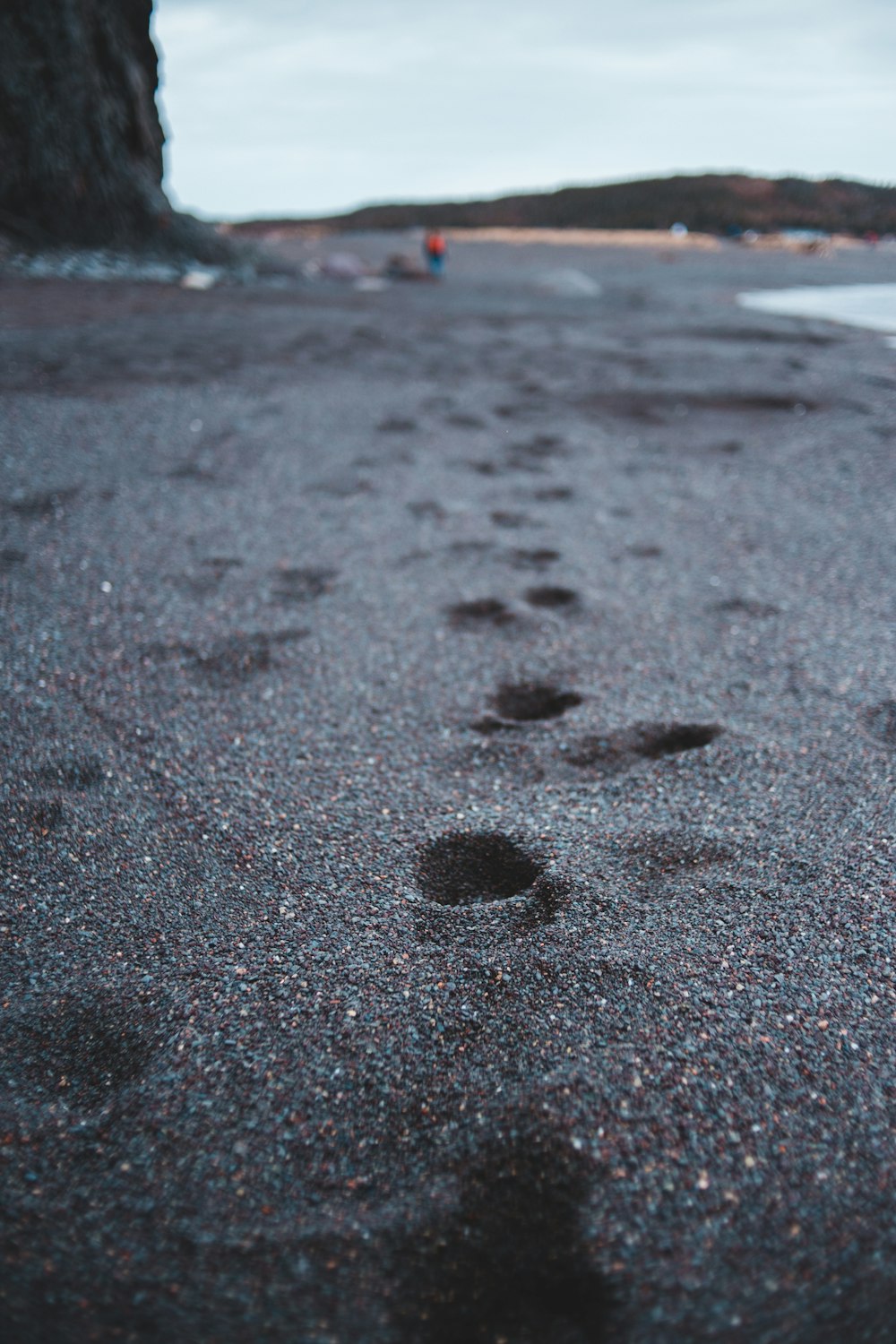 black sand on beach during daytime