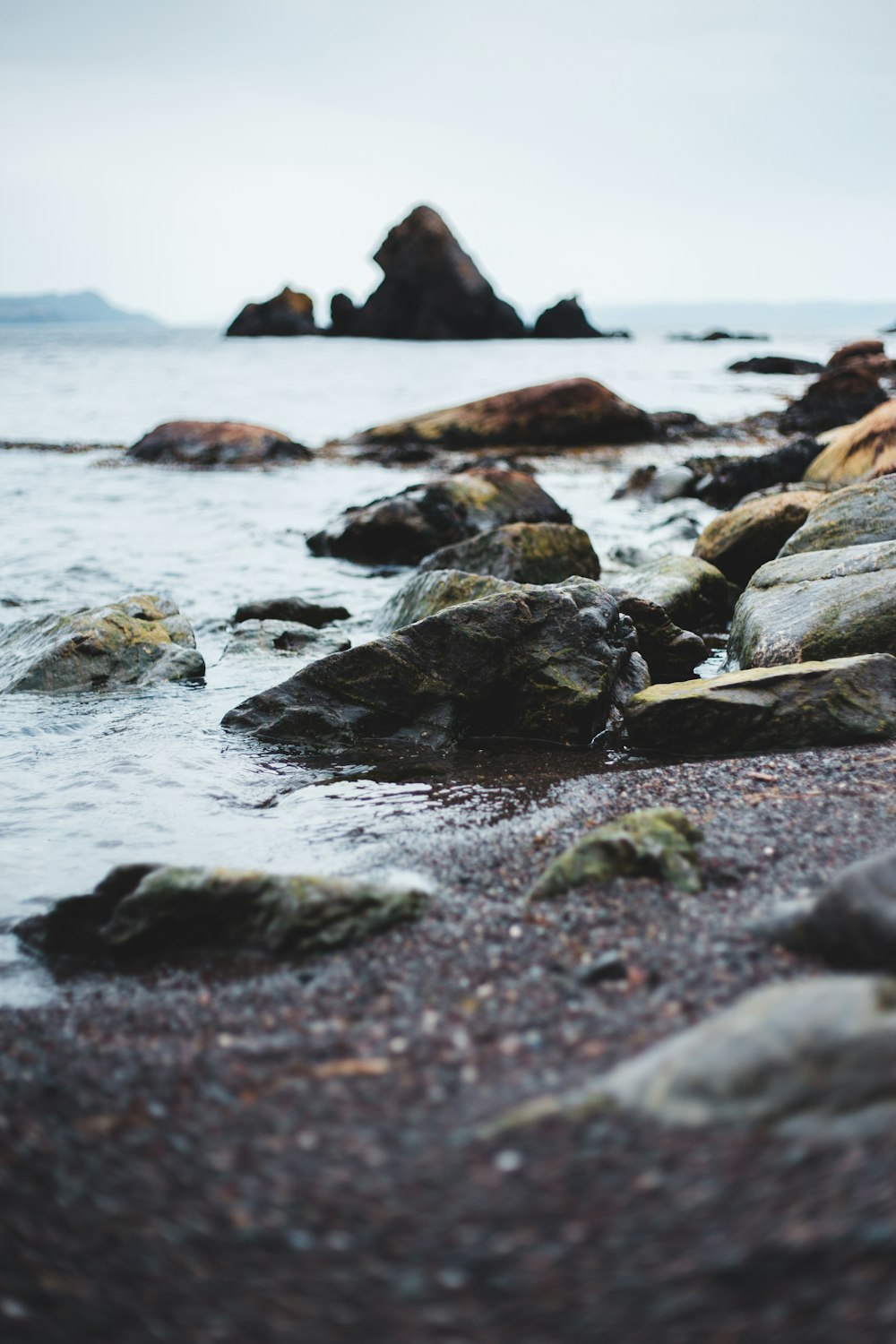 brown rock formation on sea during daytime