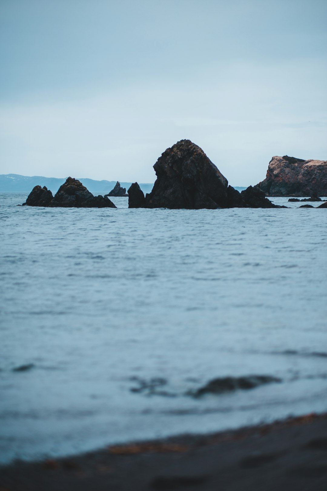 brown rock formation on sea during daytime