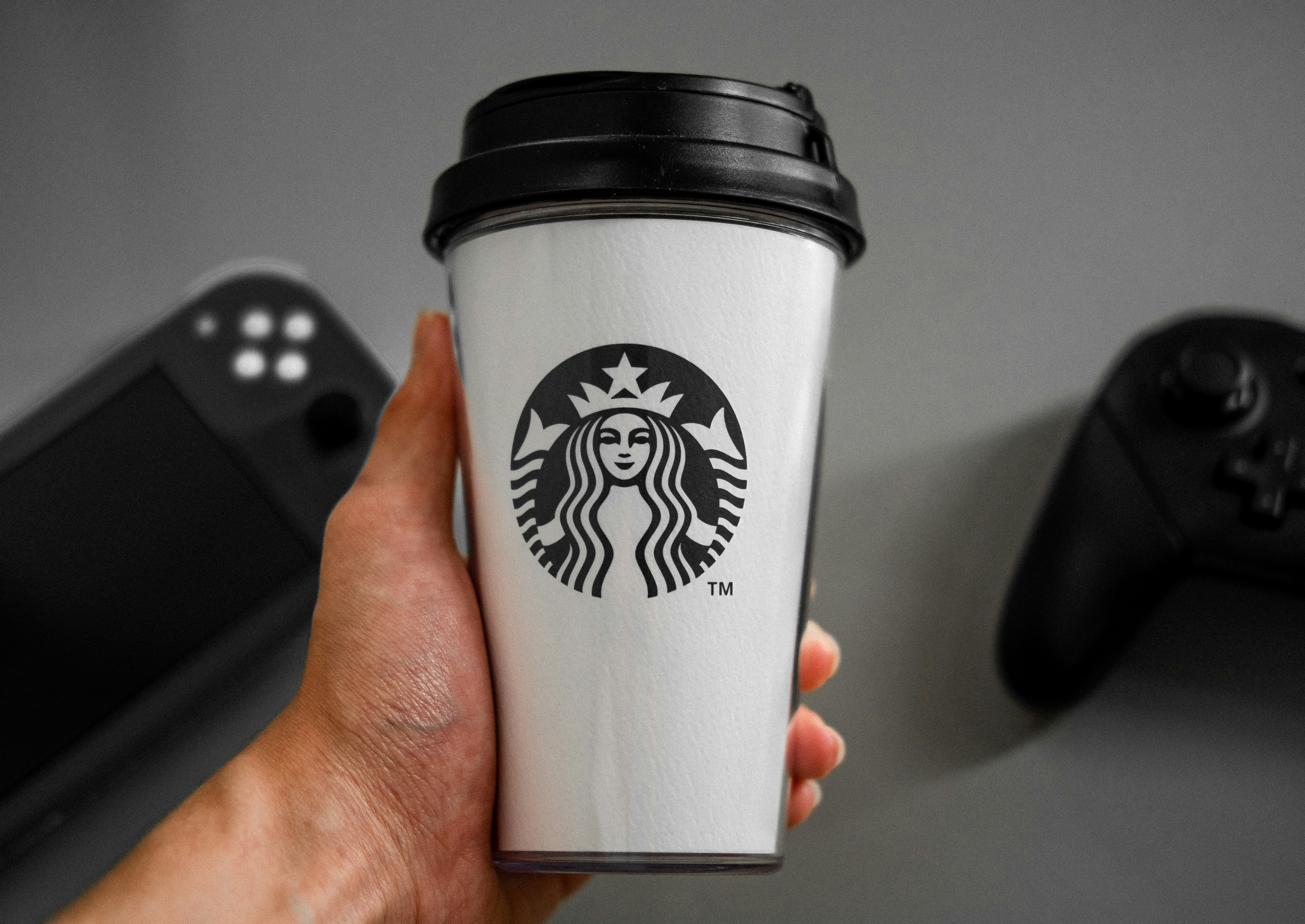 white and black star bucks cup
