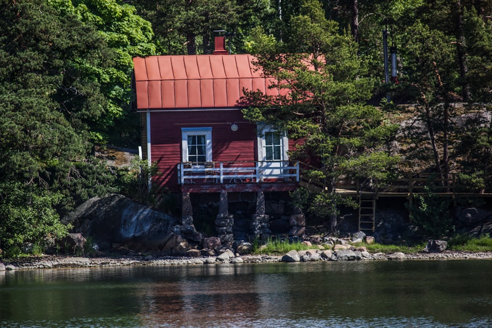 red and white house near body of water during daytime