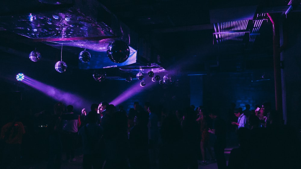 people standing on stage with lights