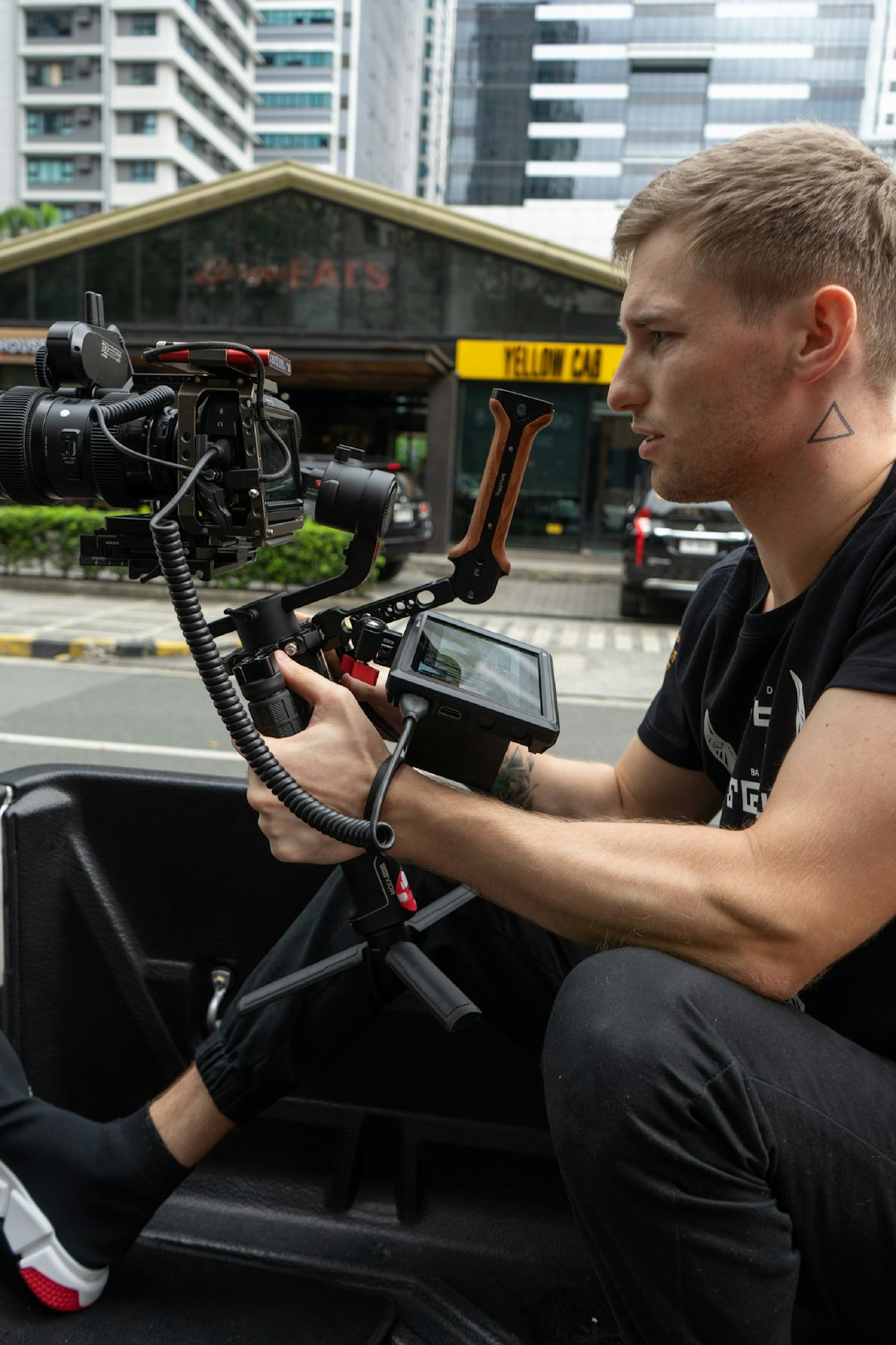 man in black and white crew neck t-shirt sitting on black car seat