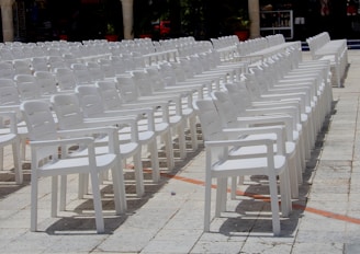 white plastic chairs on gray concrete floor