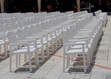 white plastic chairs on gray concrete floor