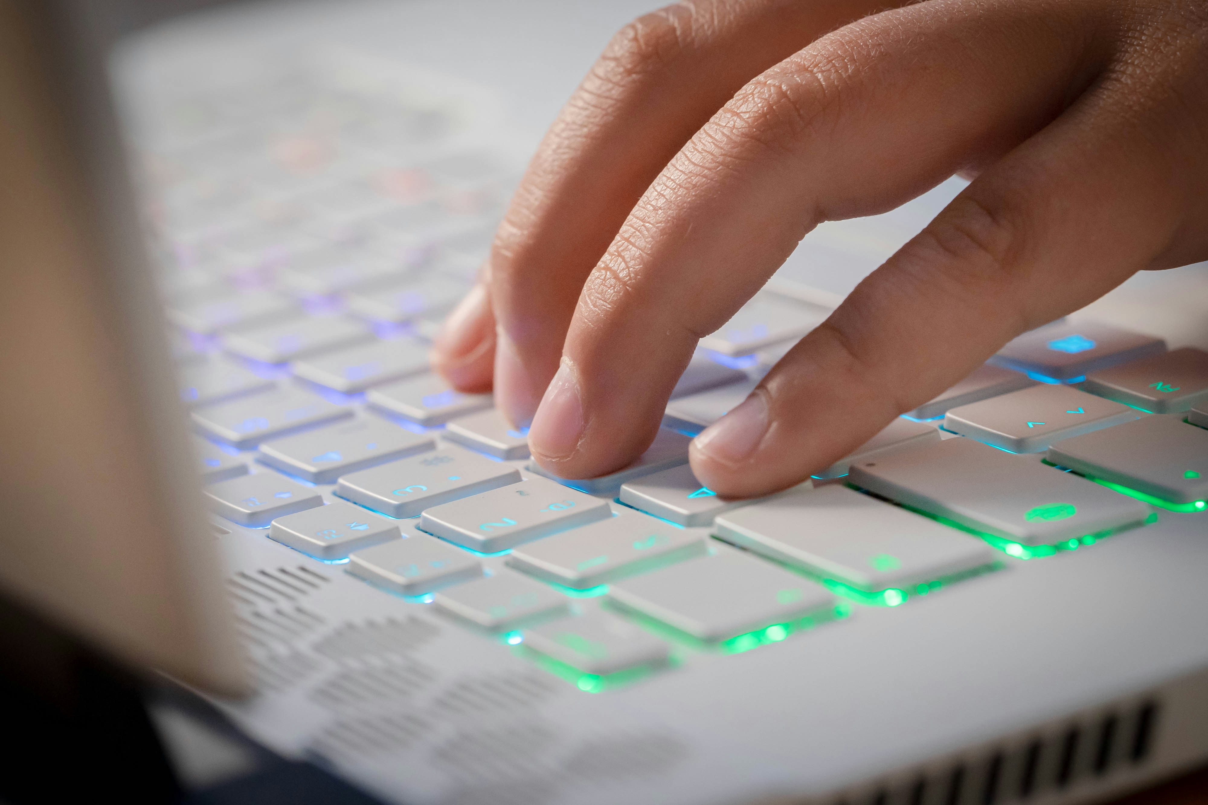 person holding white computer keyboard
