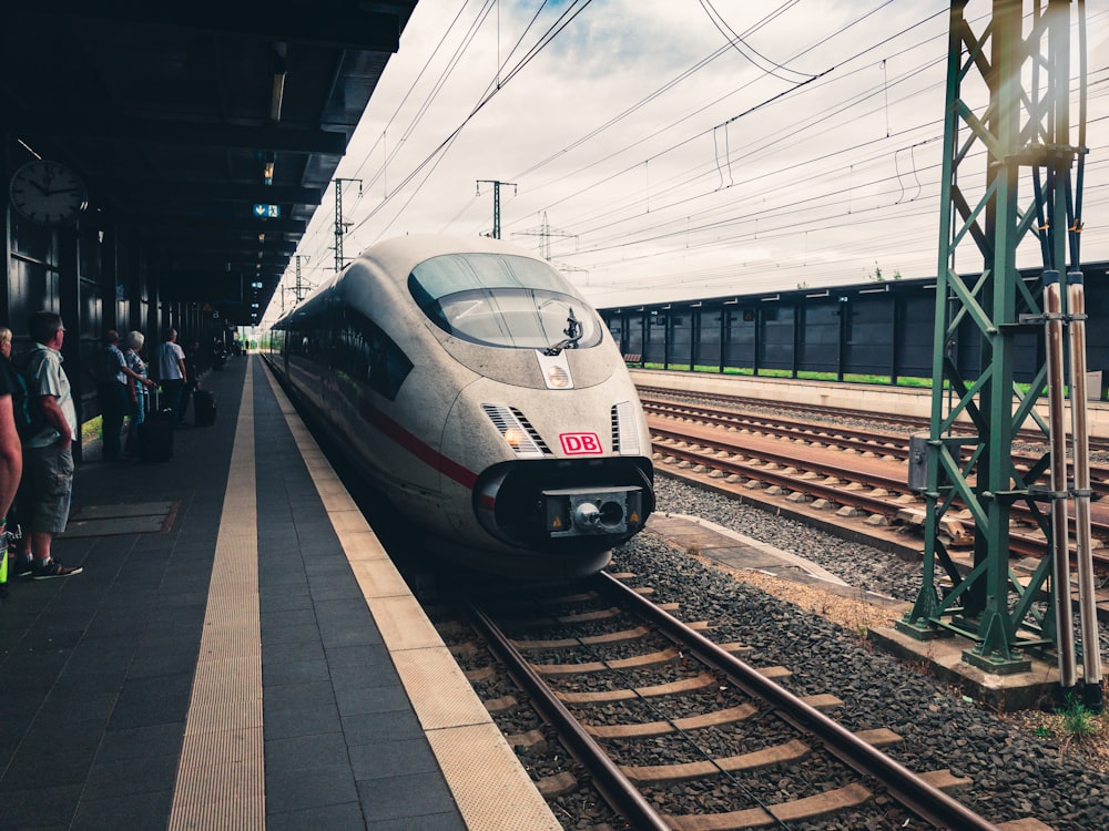 white and black train on rail way during daytime