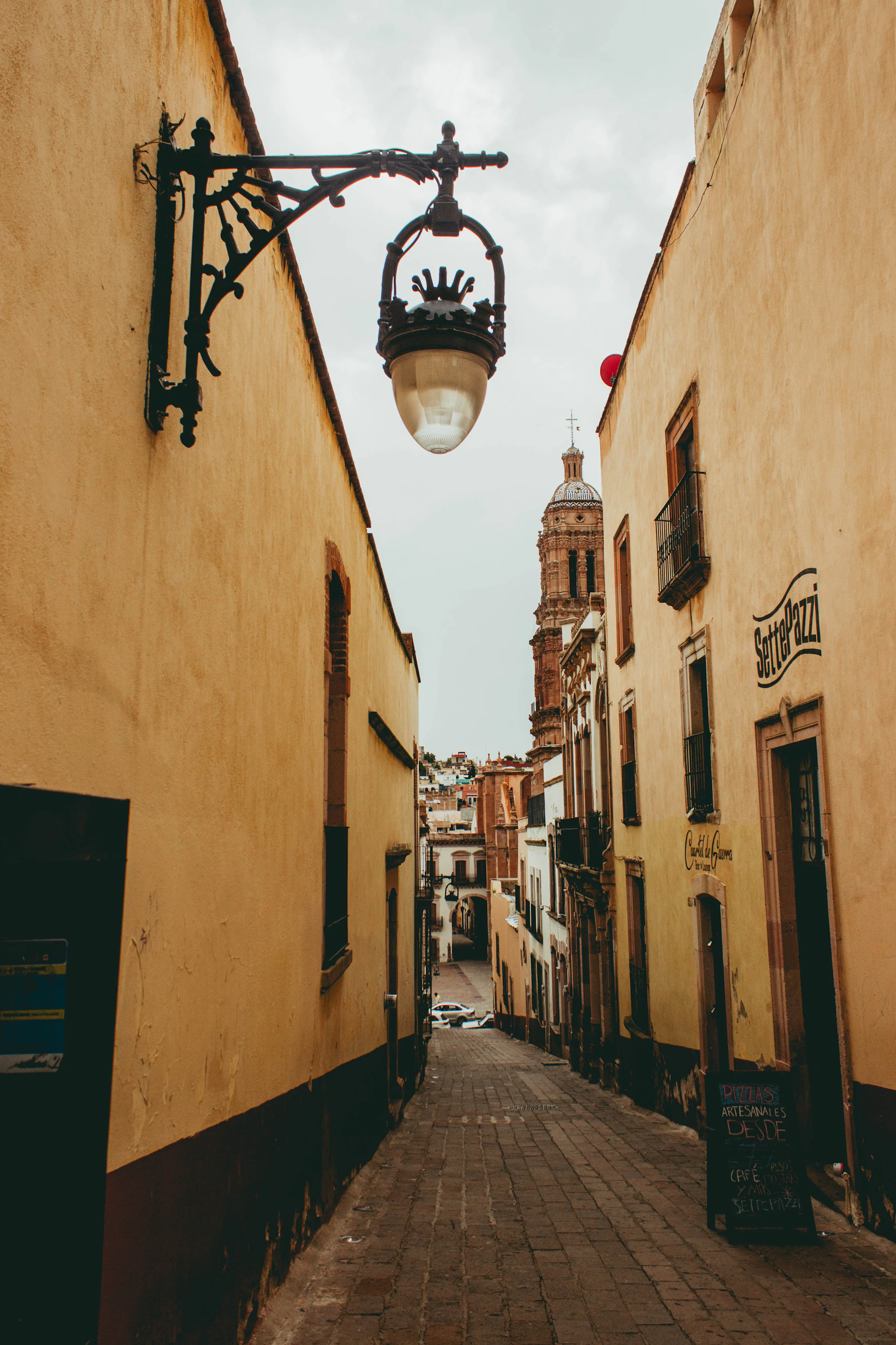 black sconce lamp on brown concrete building during daytime