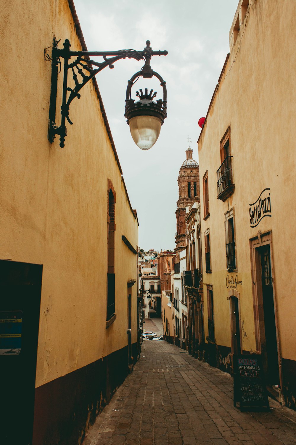 black sconce lamp on brown concrete building during daytime