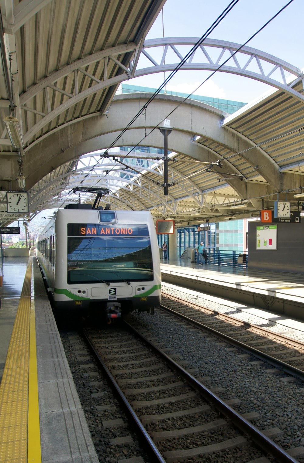 green and white train in train station