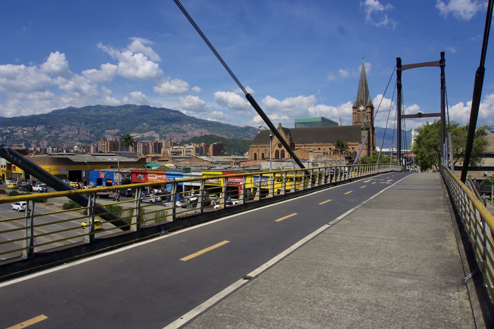 gray concrete road with cars on the side during daytime