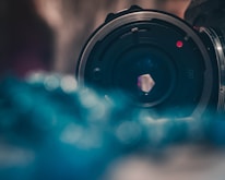 Close-up of a professional camera lens with soft background bokeh.