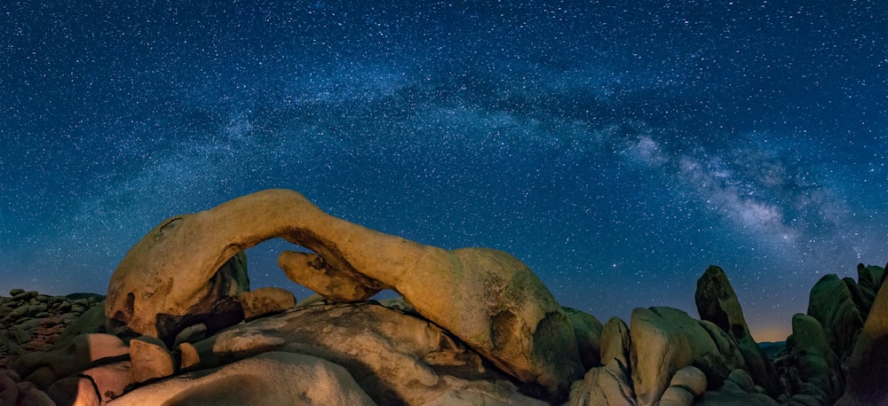 brown rock formation under blue sky