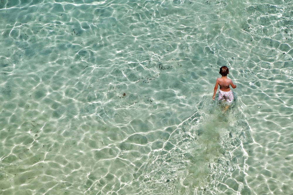 2 boys in water during daytime