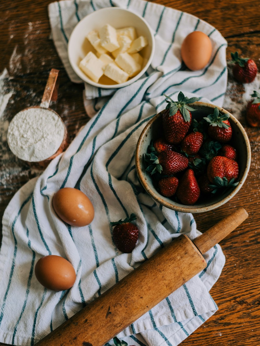strawberries and blueberries on white ceramic bowl