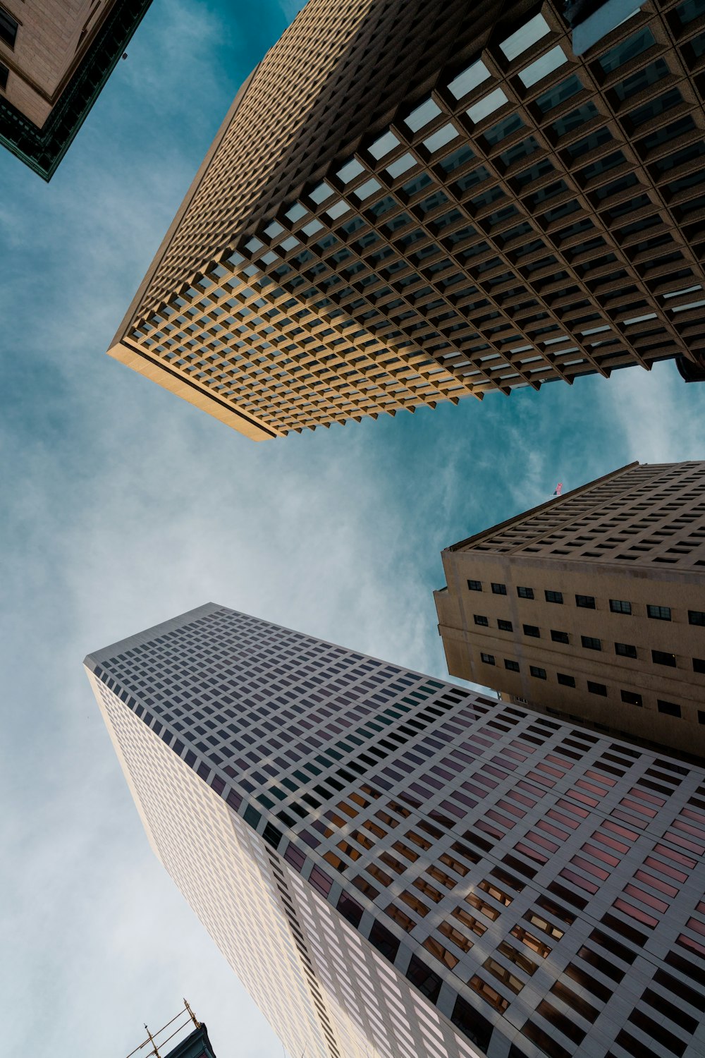 low angle photography of high rise building under blue sky during daytime