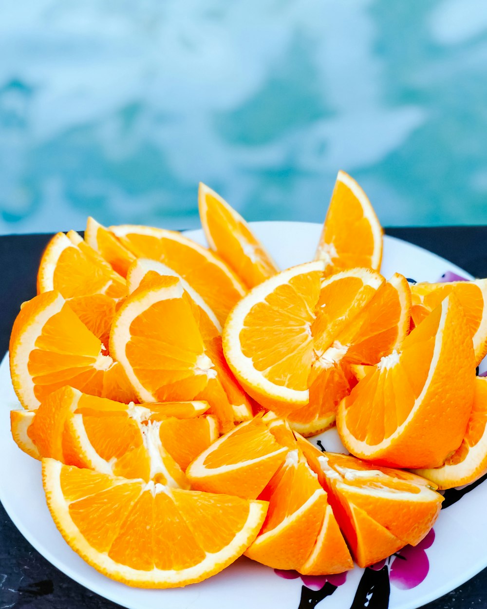 sliced orange fruit on white ceramic plate