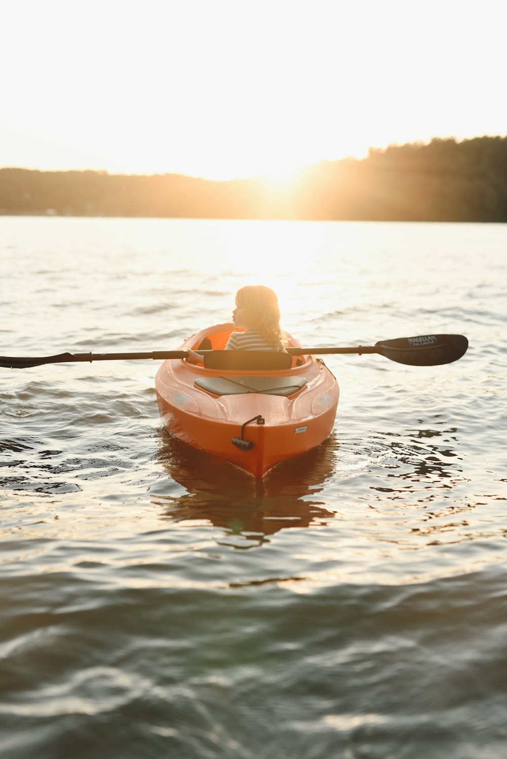 woman in yellow kayak on body of water during daytime