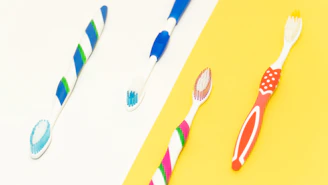 Children happily receiving colorful toothbrushes and toothpaste kits.