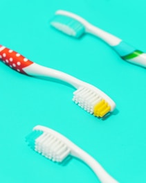 A vibrant bathroom setting featuring various toothbrushes.