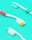 Three toothbrushes are placed on a bright turquoise background. The toothbrushes have white handles with different colored accents. One has red polka dots, another has blue and green stripes, and the last one has a simple cyan accent. The bristles of the brushes are white with some yellow and cyan highlights.