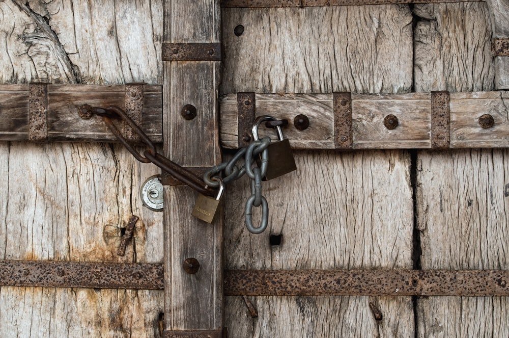 brown wooden door with padlock