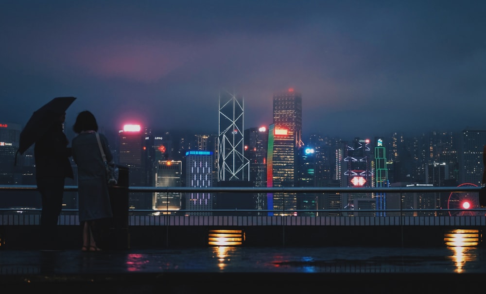 people walking on bridge during night time