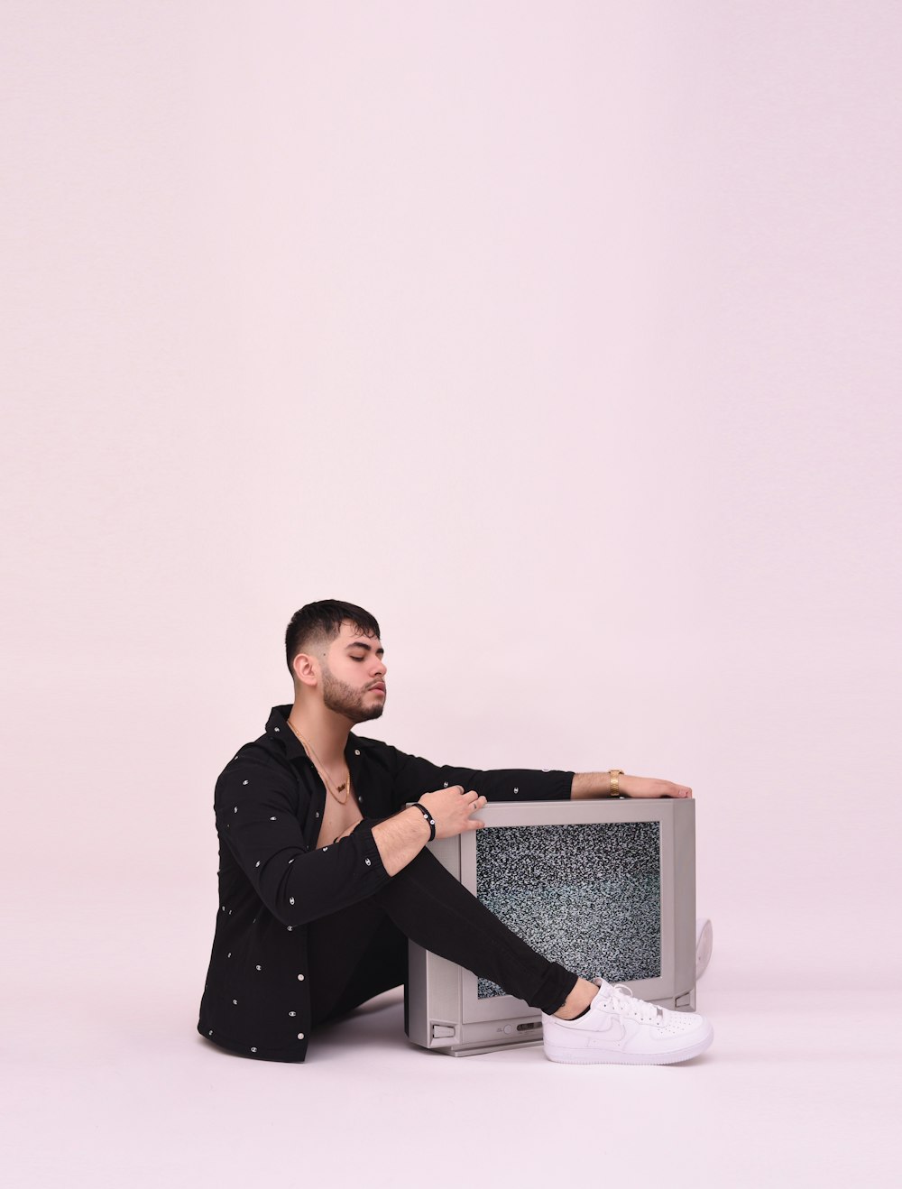 woman in black long sleeve shirt sitting on white chair