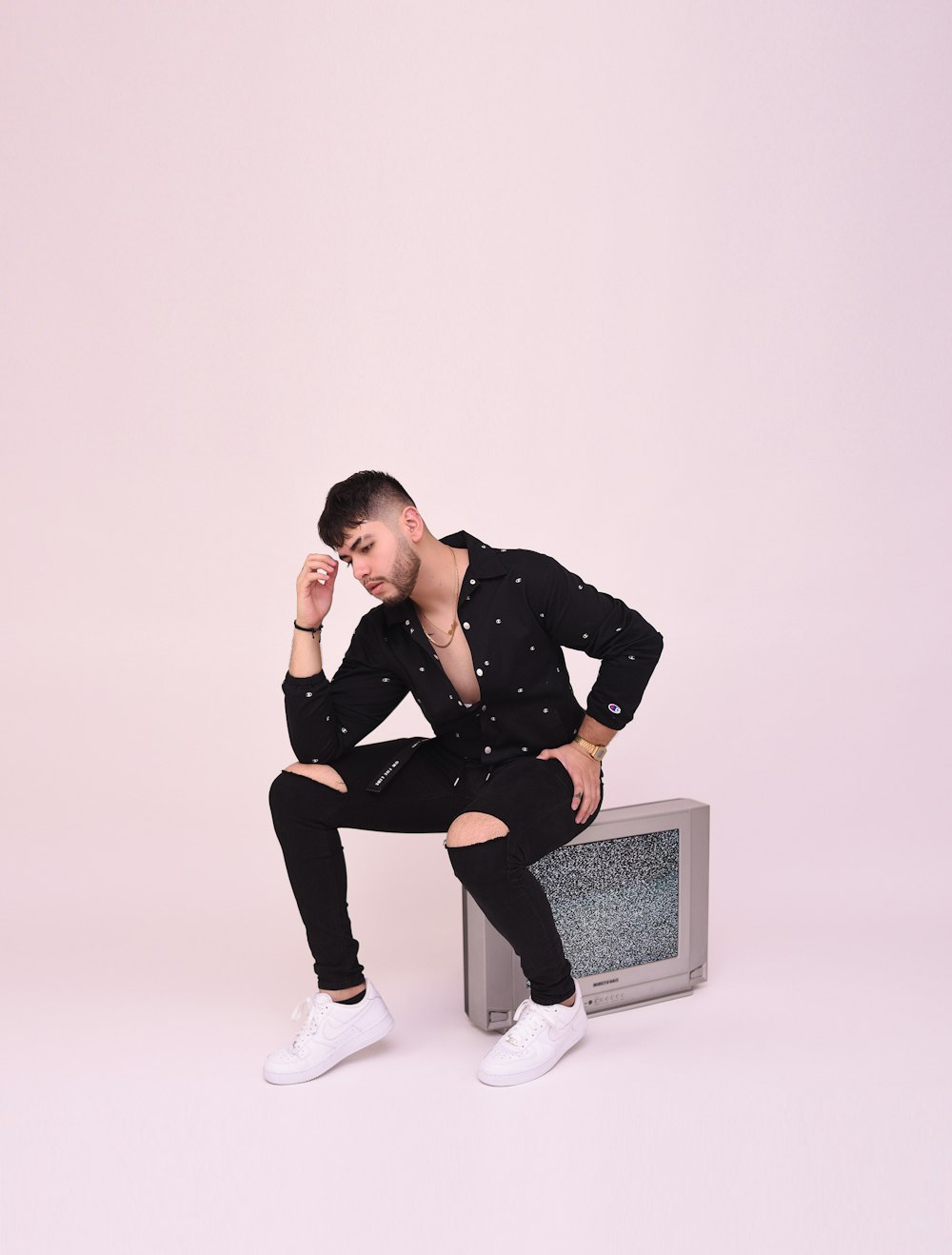 man in black jacket sitting on white chair