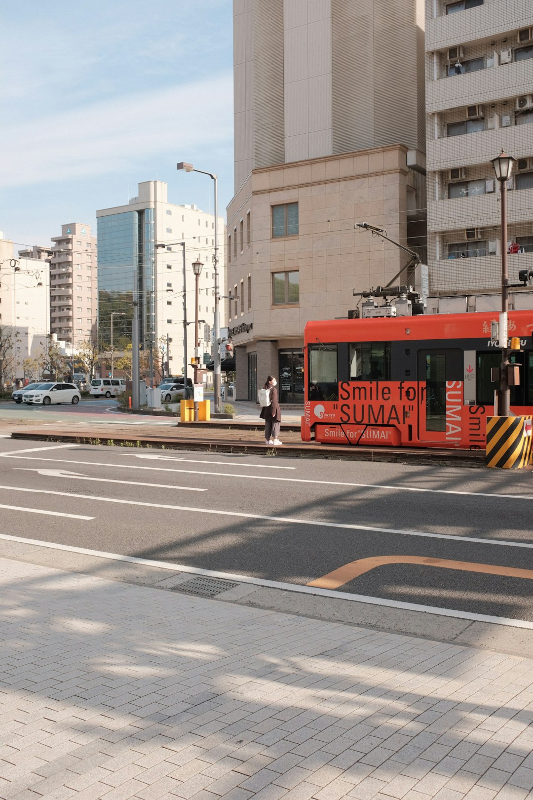 red and white tram on road during daytime