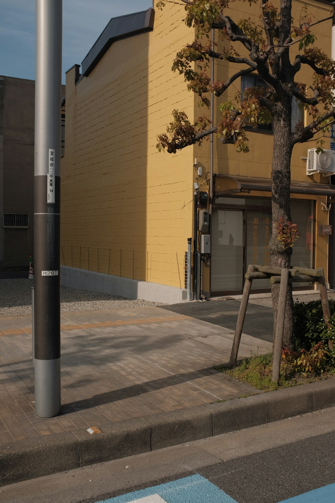 gray metal post near brown concrete building