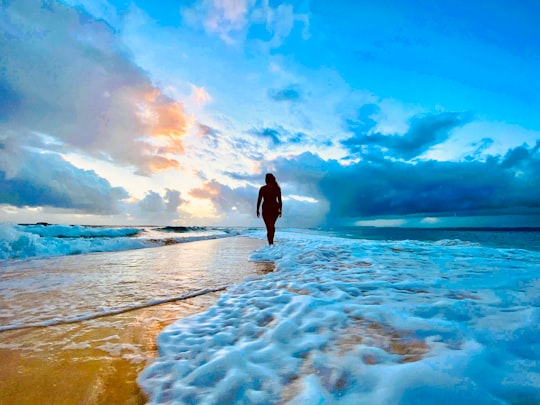 man in black jacket standing on seashore under blue and white cloudy sky during daytime in Surigao Del Sur Philippines