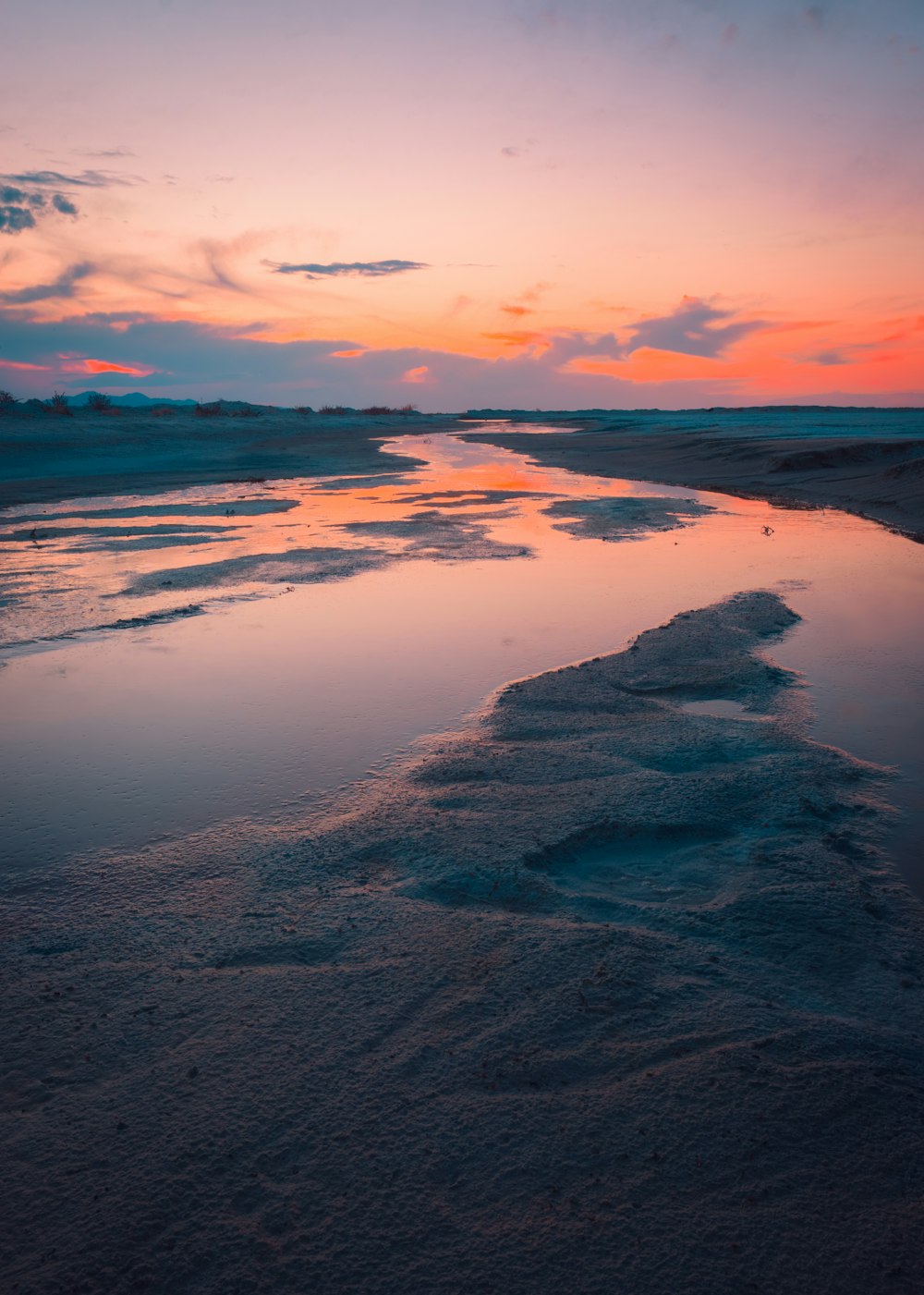 body of water under cloudy sky during daytime