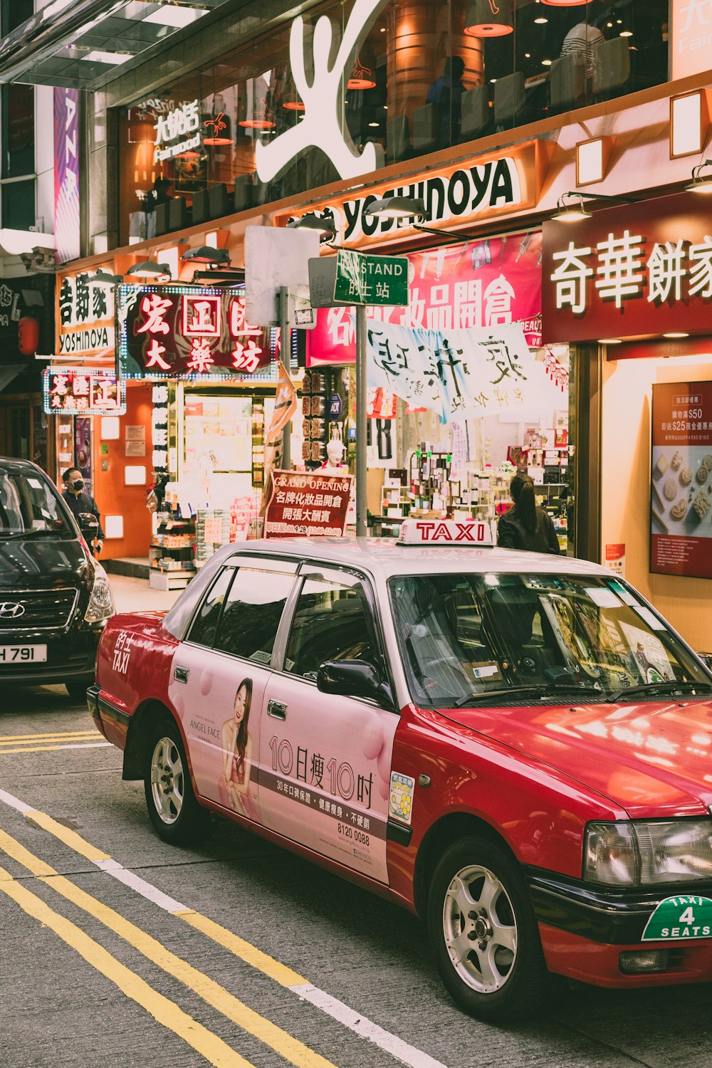 red and white sedan on road during daytime