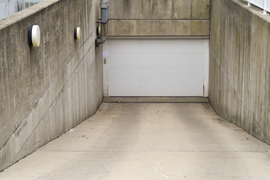 white wooden door near gray concrete wall