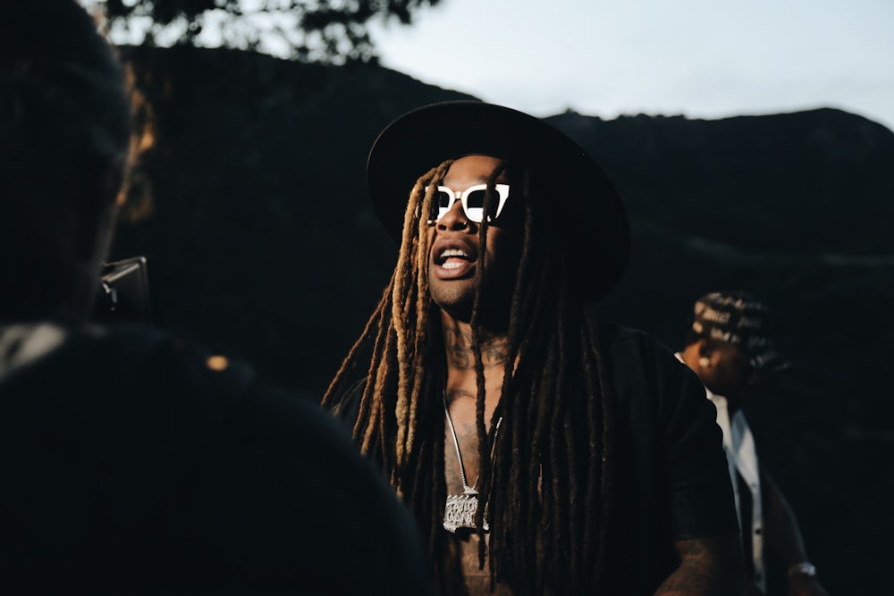 woman in black hoodie wearing black sunglasses