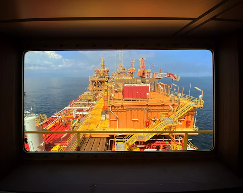 A detailed close-up of offshore structural blueprints with overlay of AI data analysis visuals.