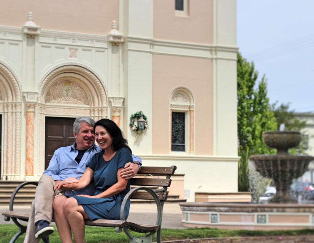 man and woman sitting on bench