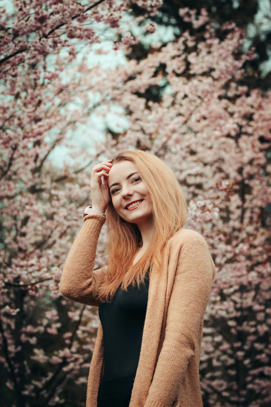 woman in brown sweater smiling