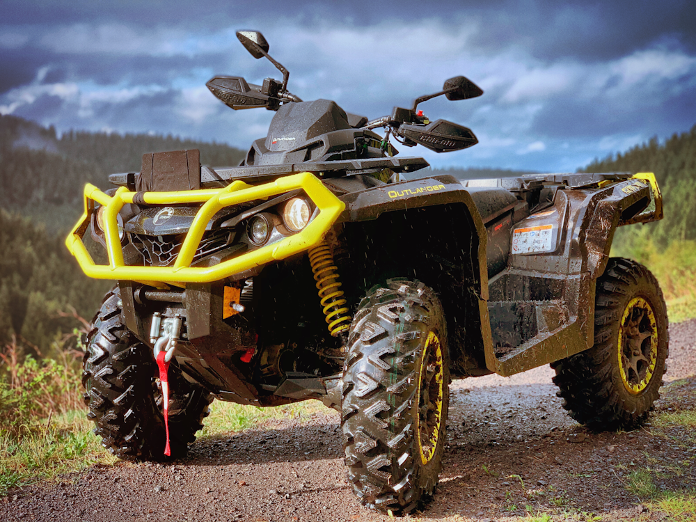 yellow and black atv on brown dirt ground during daytime