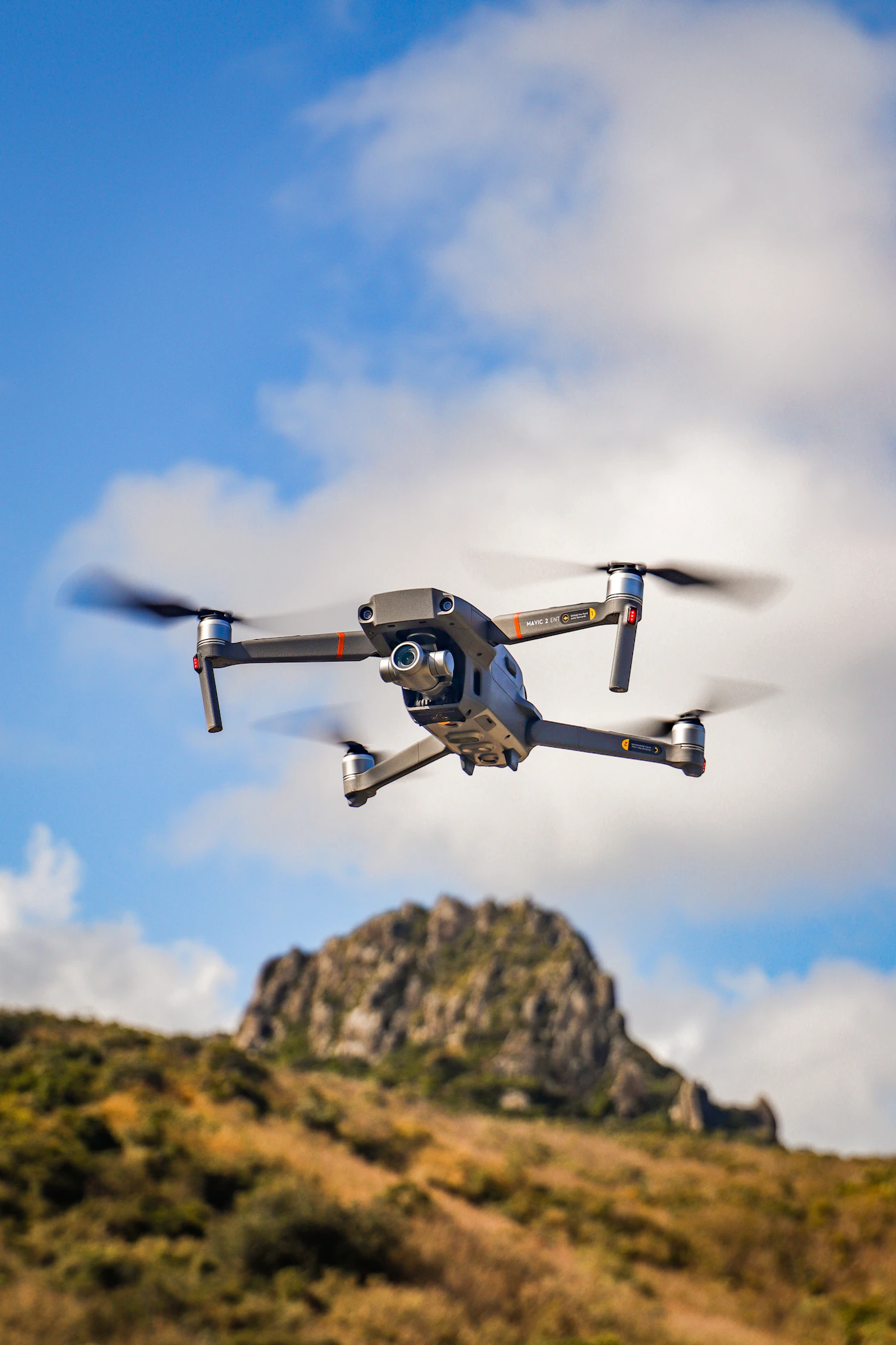 Drone in flight against a bright sky