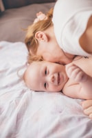 A mother lovingly holding her newborn wrapped in a soft blanket.