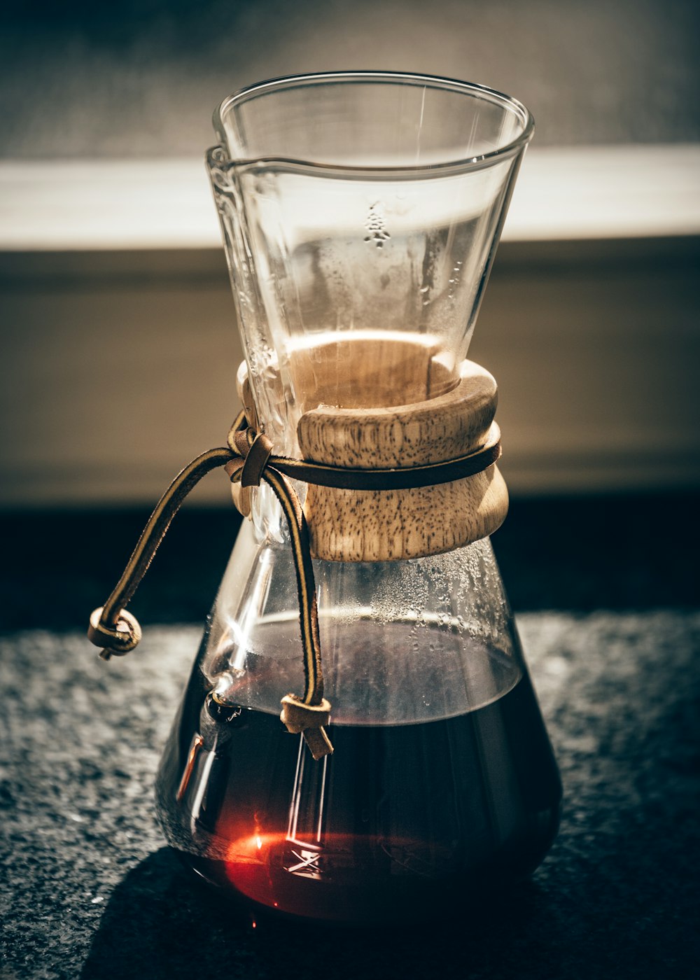 clear glass pitcher with brown liquid