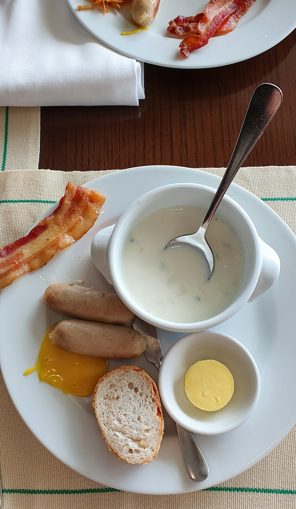 white ceramic bowl with soup beside bread